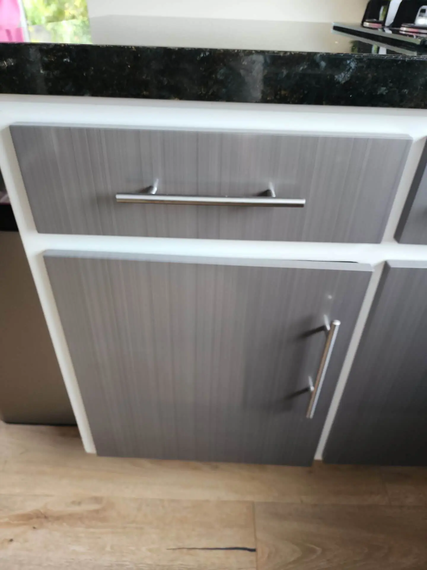 Modern kitchen cabinet refinishing with sleek grey drawer fronts and clean lines, professionally finished by Sucro Painting Contractors for a smooth, contemporary look.
