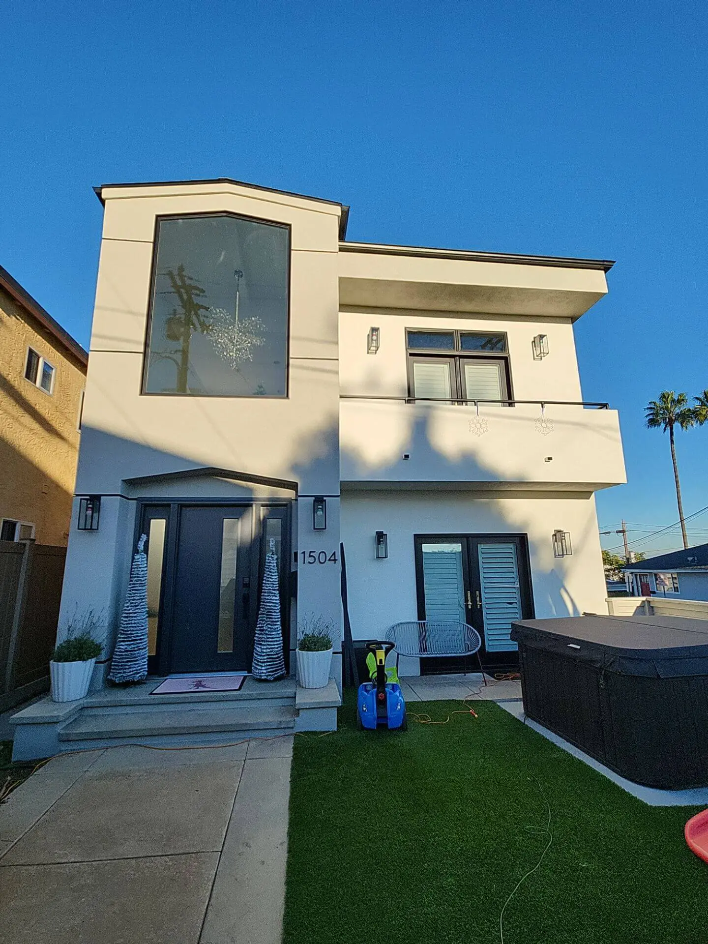 Modern two-story home with fresh exterior paint, clean stucco finish, and sharp trim details, completed by Sucro Painting Contractors as part of a professional residential painting project.