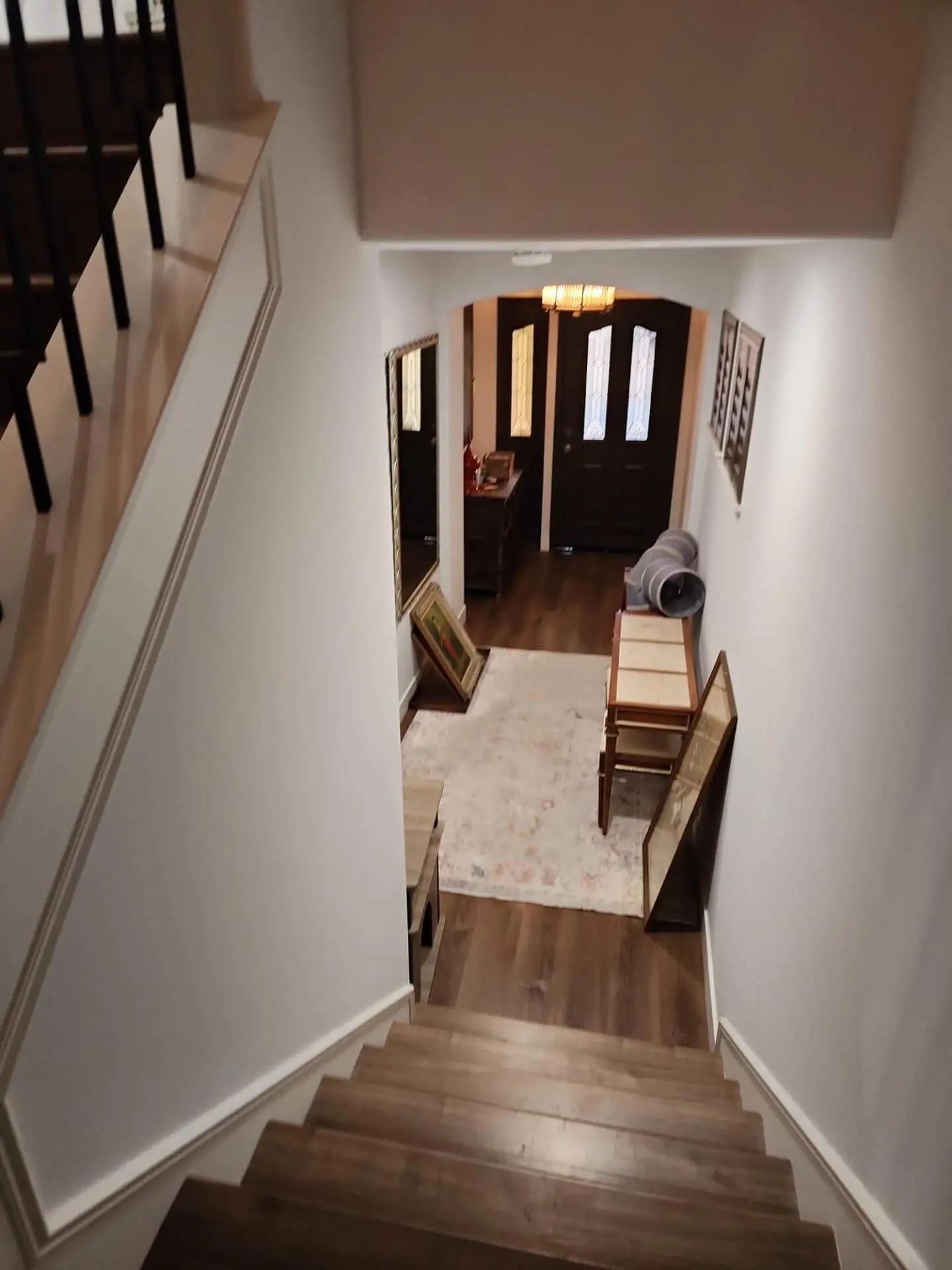 Freshly painted stairwell and entryway with clean white walls and crisp trim, showcasing detailed interior painting work completed by Sucro Painting Contractors.