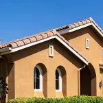 Stucco exterior on a Southern California home with clay tile roof and arched windows