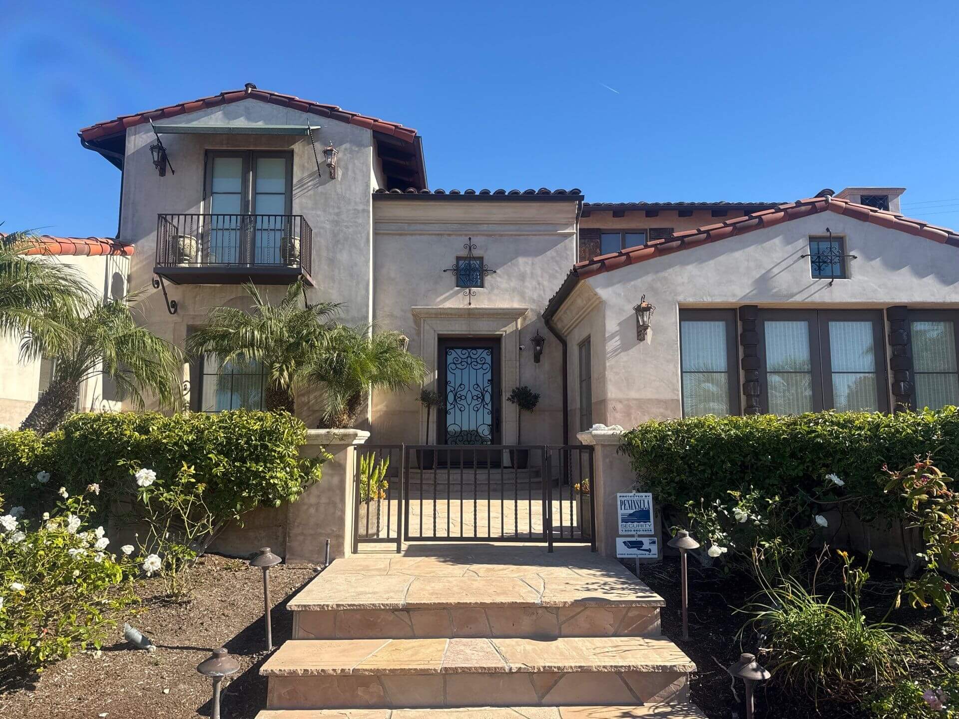 Elegant Mediterranean-style home exterior with smooth stucco finish and detailed trim, professionally painted by Sucro Painting Contractors for a clean, timeless curb appeal.