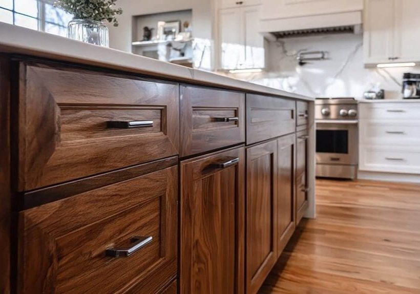 Kitchen island with wood cabinets showing cabinet refinishing vs replacement decision in a modern home